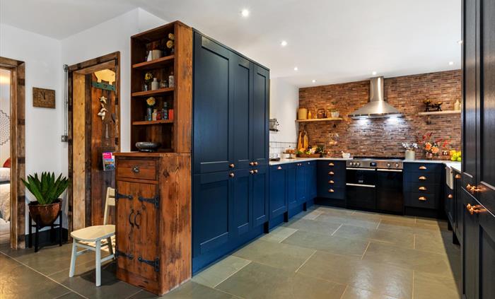 ample storage cupboards, reclaimed handmade wooden cupboard, slate flooring with underfloor heating
